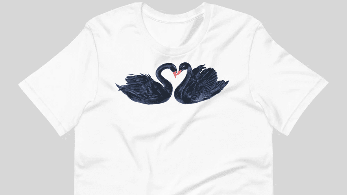 White t-shirt with two blue swans in the shape of a heart design